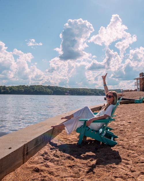 woman soaking up the sun on a beach at the Lake of the Ozarks